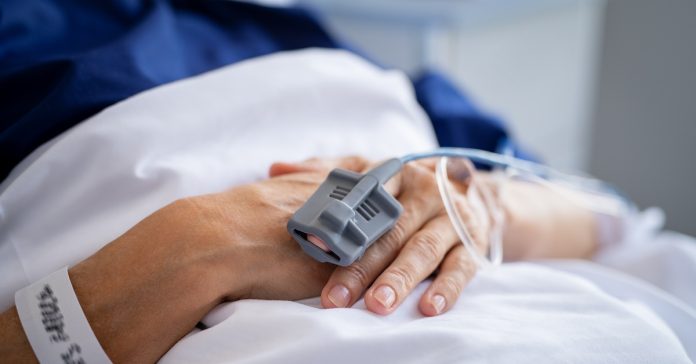 Patient hands with IV drip in hospital